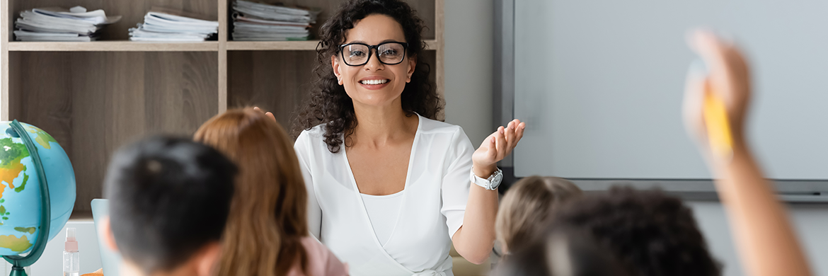 Woman smiling and talking to a classroom